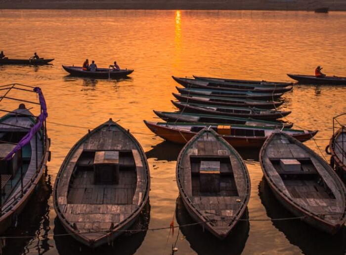 Travelers exploring the historic ghats of Varanasi along the Ganges during a three-day Varanasi itinerary