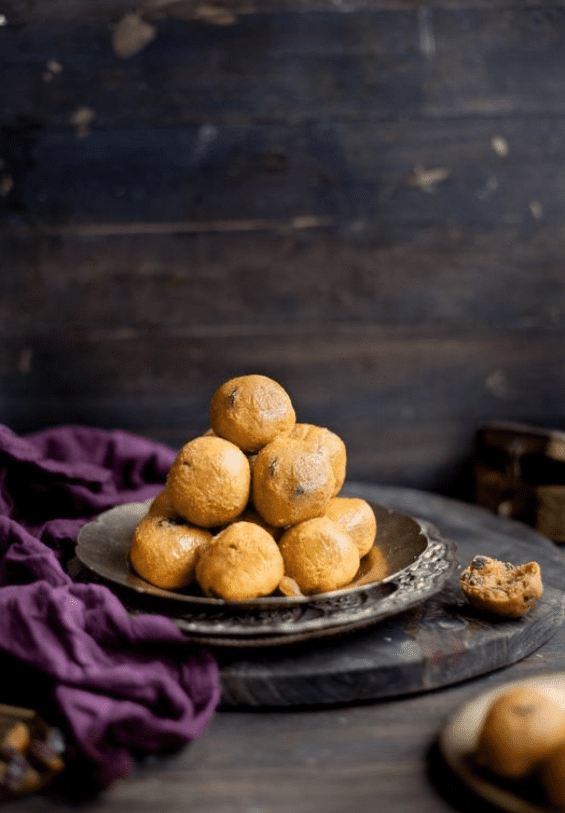 A plate of huge besan ke laddoos piled on top of each other