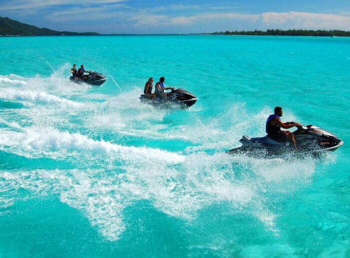 Tourists enjoying adventurous watersports along the beaches of Goa