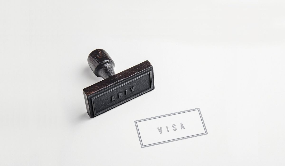 Traveler checking flight details before receiving a visa decision