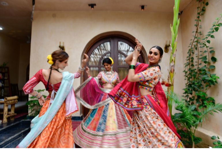 7 Garba And Dandiya Nights In Delhi-NCR To Book This Navratri 1 People performing Garba and Dandiya at a Navratri celebration in Delhi-NCR